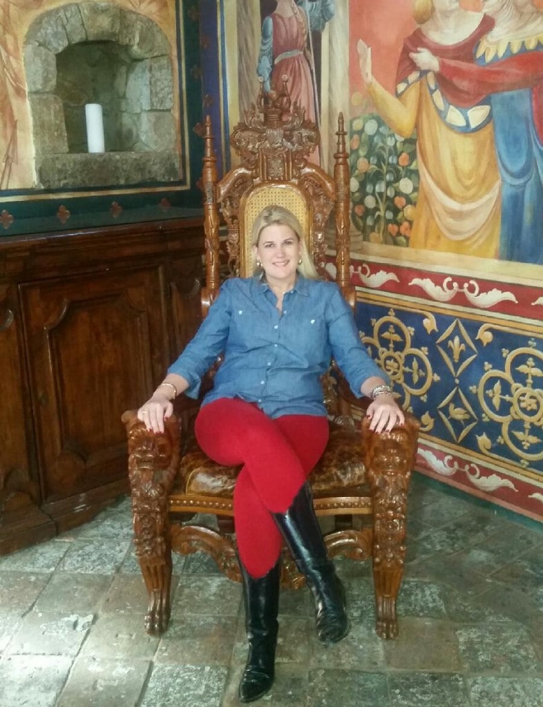 Katherine sitting in an ornate chair in the castle in Napa