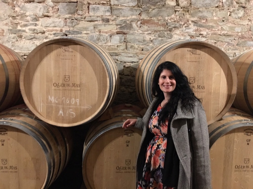 Anisa with the barrels of wine at the Oller del Mas winery. - "Montserrat: Mountain, Monastery, and Wine" - Two Traveling Texans