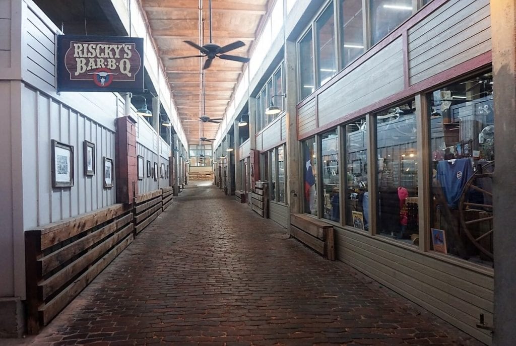 Inside Stockyard Station you can still find feed bins (reddish box on the left wall) - "Fort Worth Stockyards: Learn About the Old West" - Two Traveling Texans
