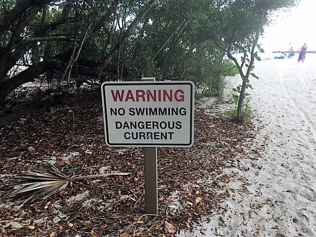 Heed the warning sign at Blind Pass Beach! - "The Search for Sanibel Island Shells" - Two Traveling Texans
