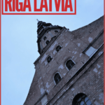 looking up at the tower of st. peters church in riga, where you can get one of the best views of the city