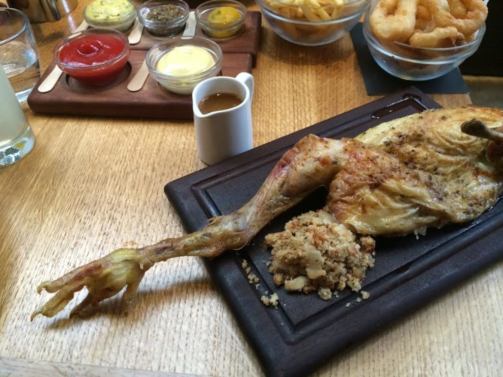The Indian Rock Chicken From Cock and Bull, served with feet and nails intact. - The Best Restaurant in Shoreditch - Two Traveling Texans