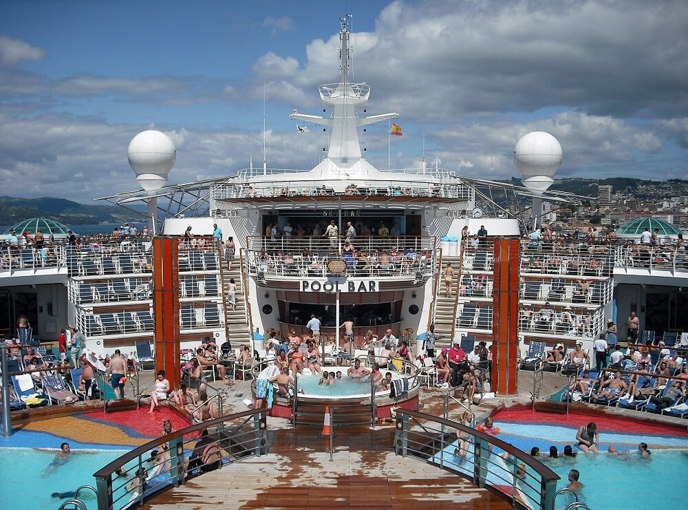 The main pool area on a cruise is the hub of activity on a day at sea - Cruise Pros and Cons- Two Traveling Texans