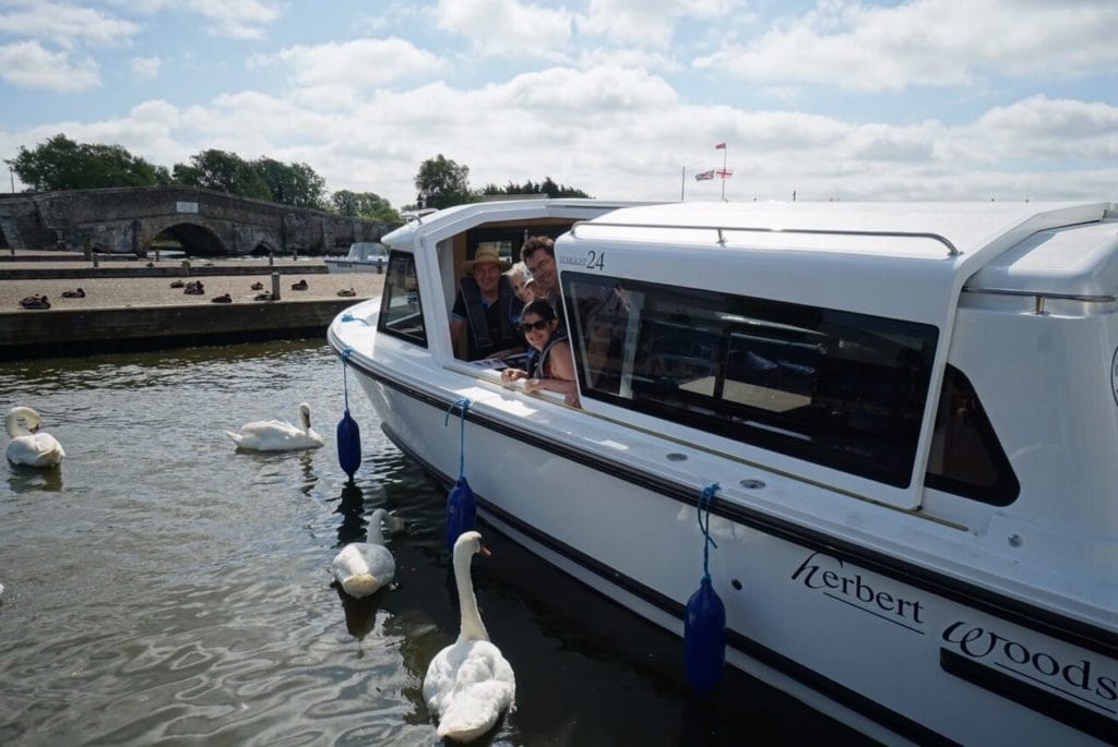 We are all onboard our boat and surrounded by swans! - "Hire a Boat on the Norfolk Broads" - Two Traveling Texans