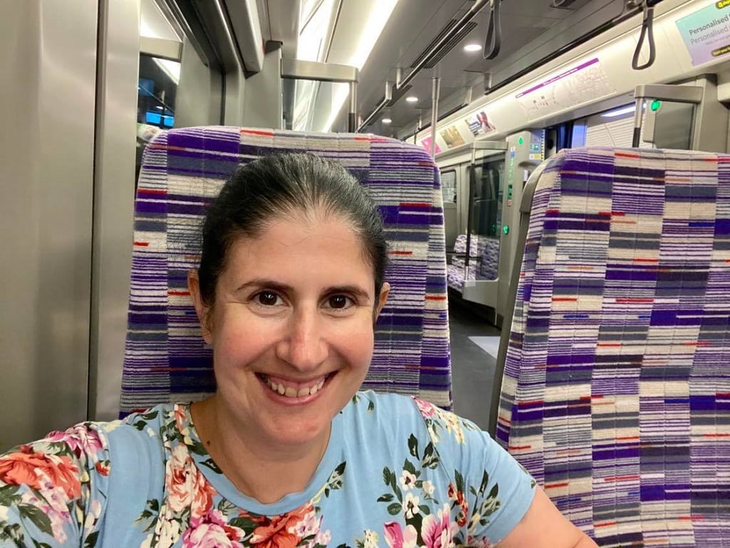 selfie of anisa sitting on the new trains of the Elizabeth line in London