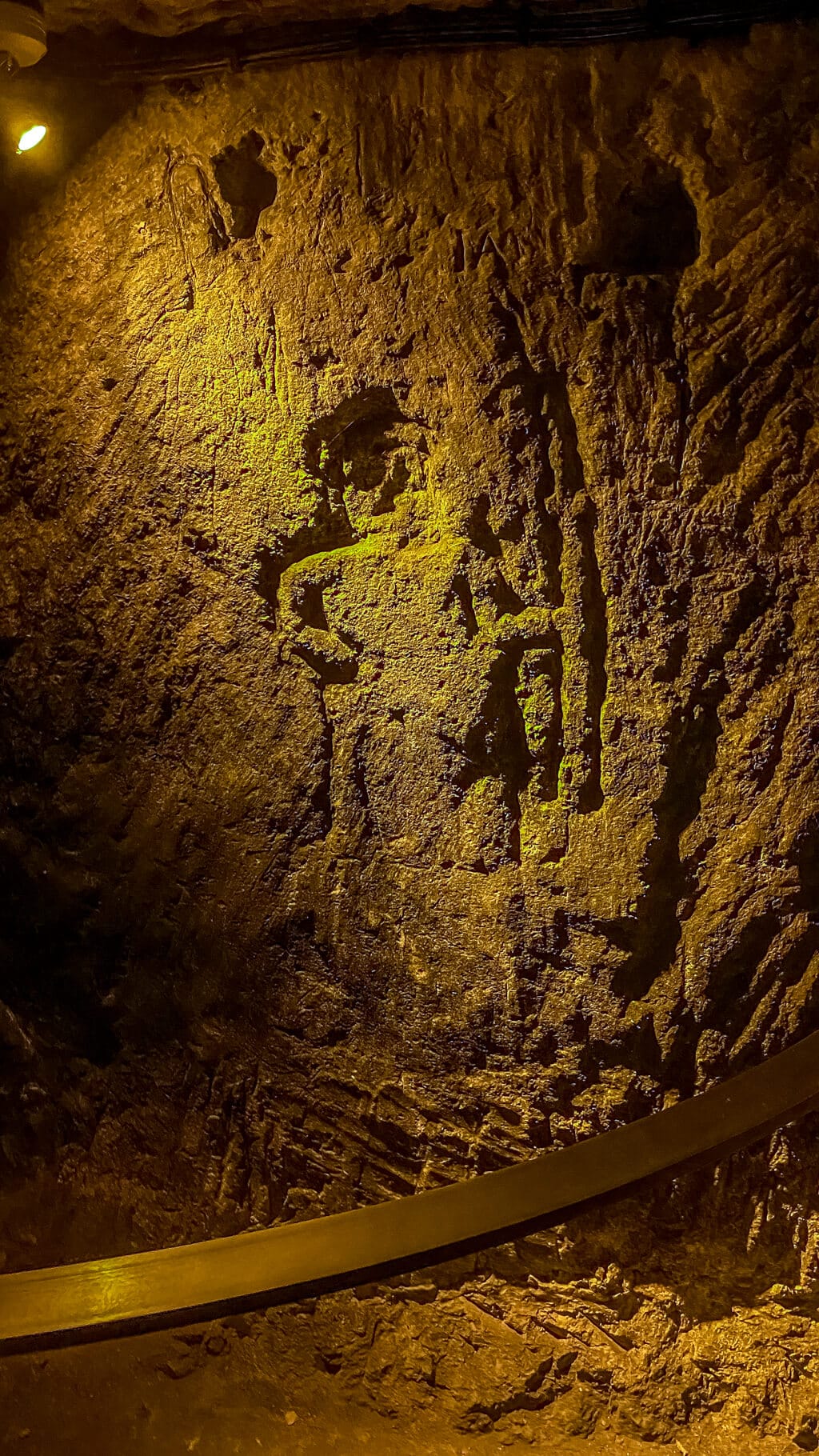 an archer and woman are visible carved into the walls of the cellars at Champagne Pannier