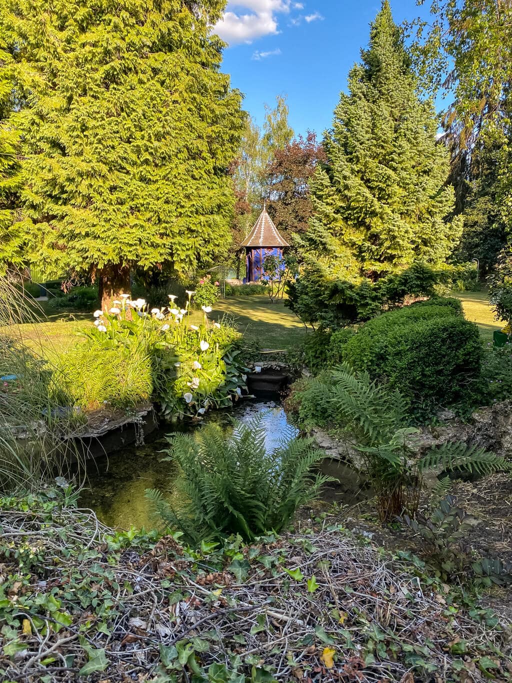 view of the garden looking over a small lake