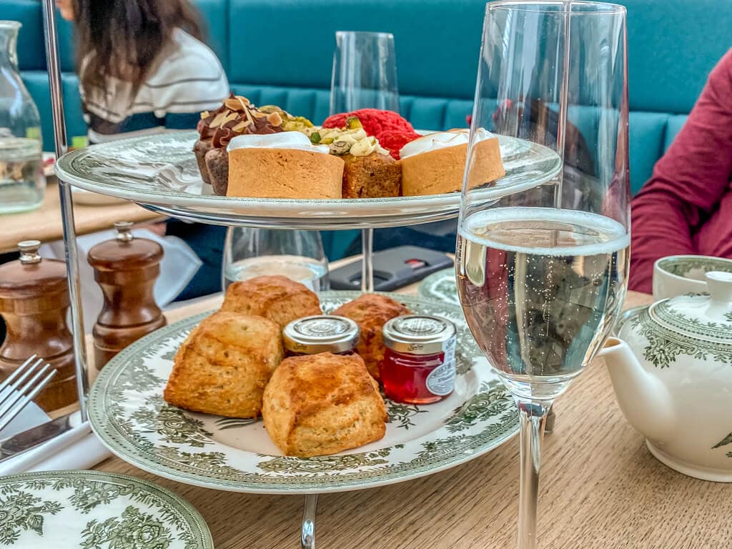 two levels of the tiered afternoon tea with glass of proseco