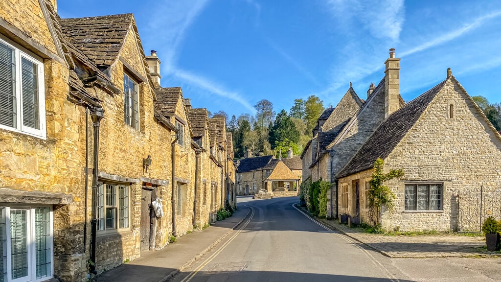 main street in castle combe england with market cross in the background