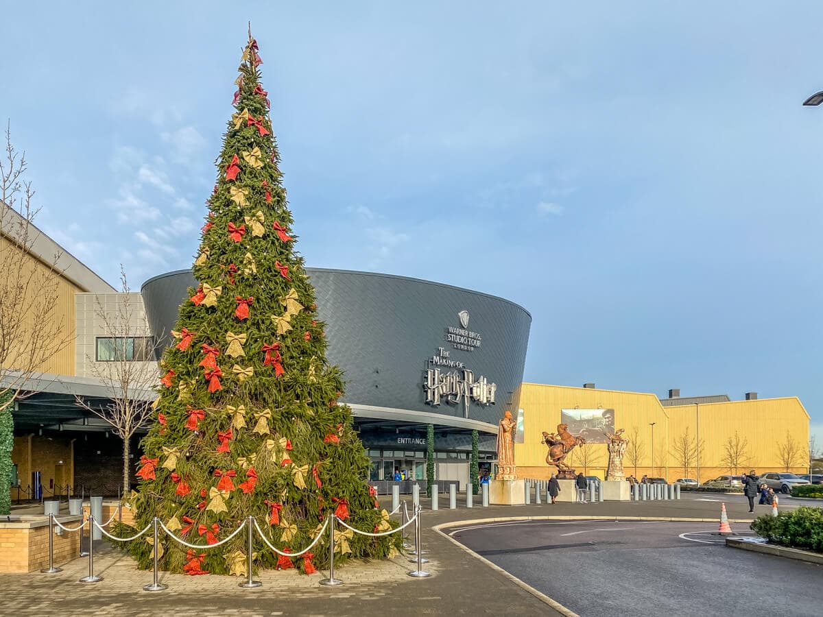 exterior of harry potter studios entrance with a big Christmas tree in front