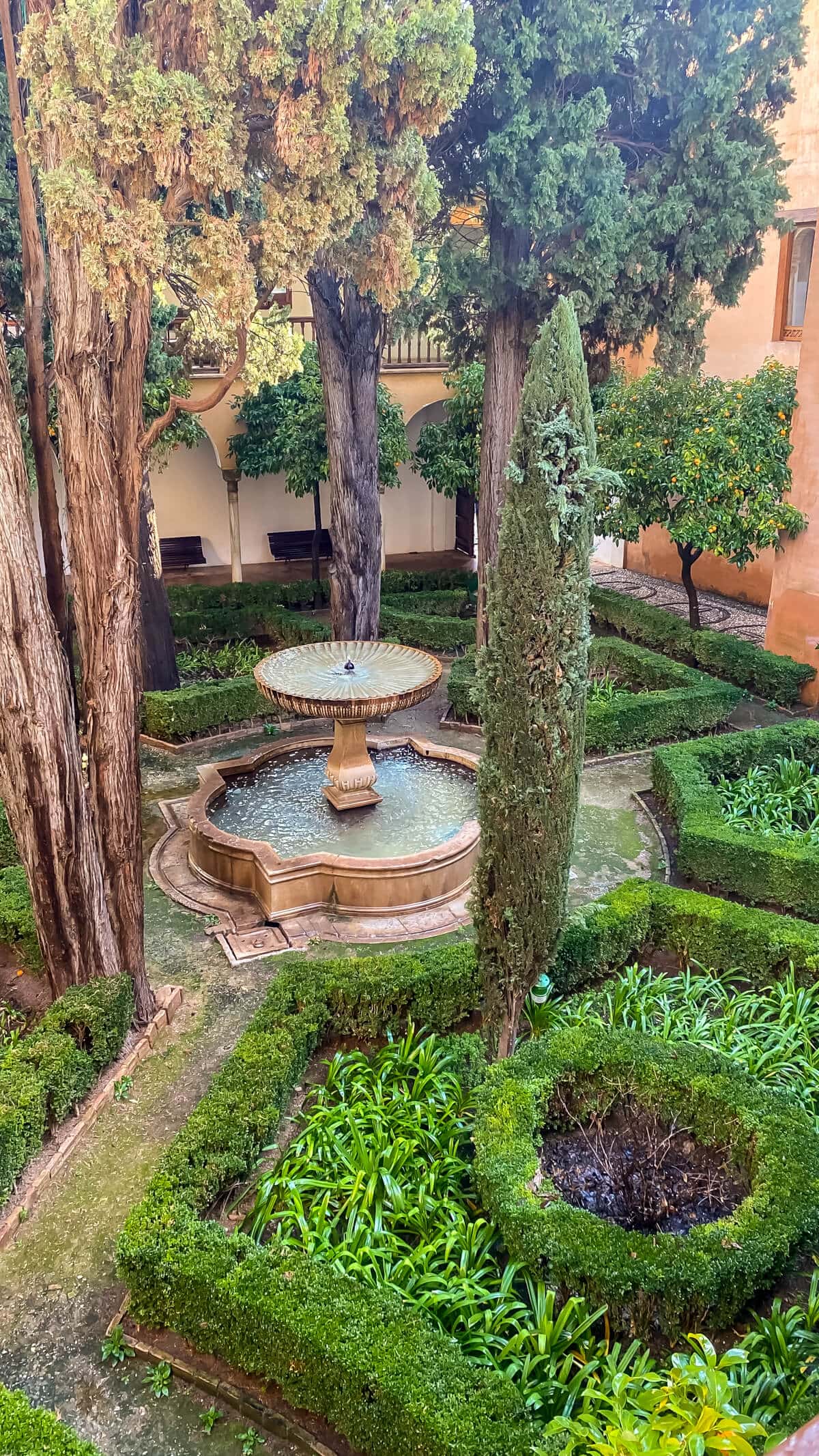 looking down on a courtyard garden with a fountain