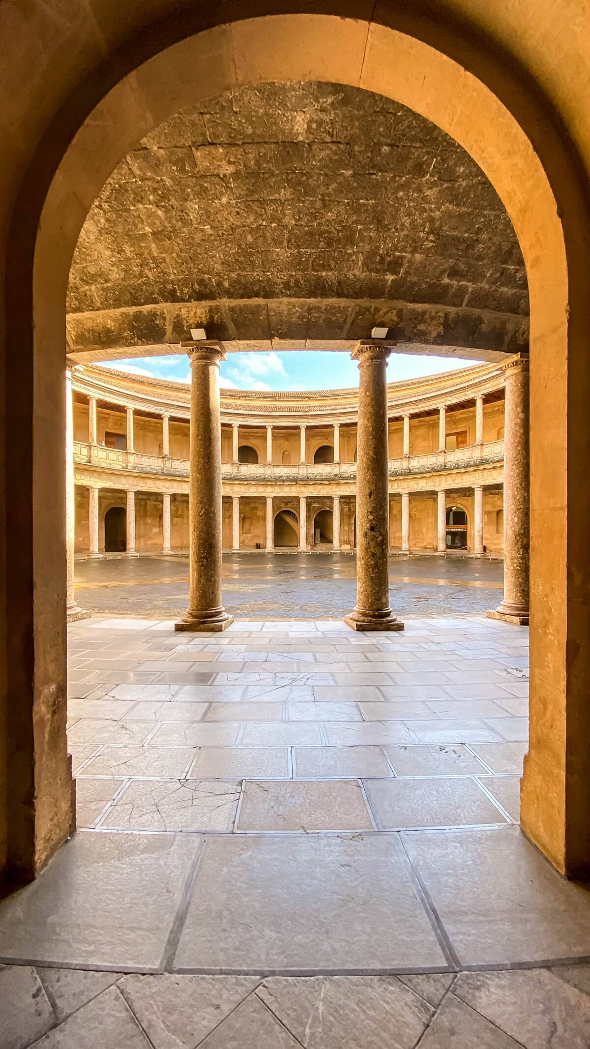 looking through a arch into the courtyard of Charles v palace with all its columns