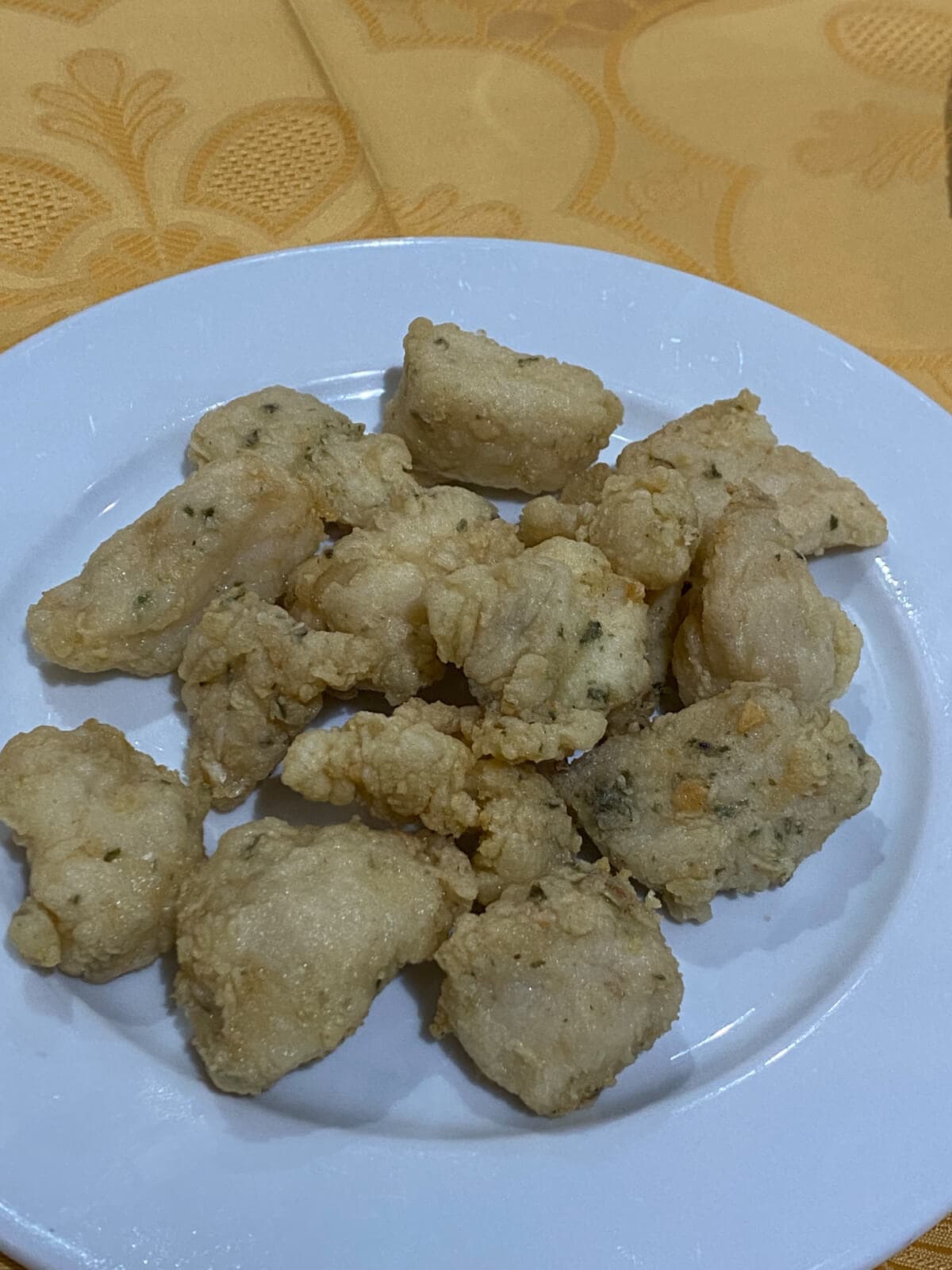 pieces of fried fish on a white plate