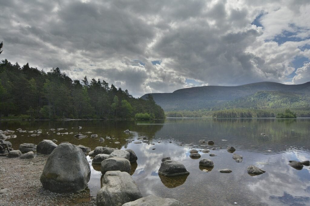 lake in cairngorms national park with mountains in the background