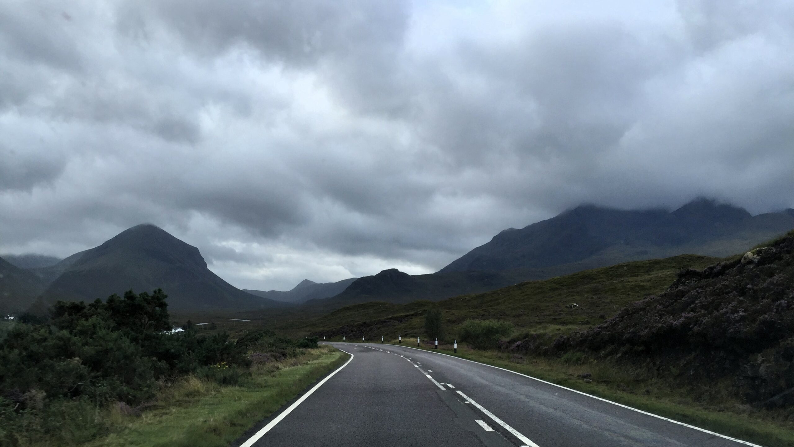road on the Isle of Skye in the UK through the mountains on a cloudy day